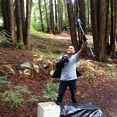 A UCSC Campus Natural Reserve stewardship intern cleans up the campus.